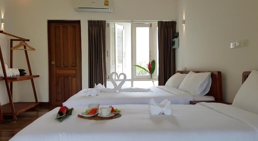 a white bed sitting next to a white table, Vang Vieng Eco Lodge in Vang Vieng