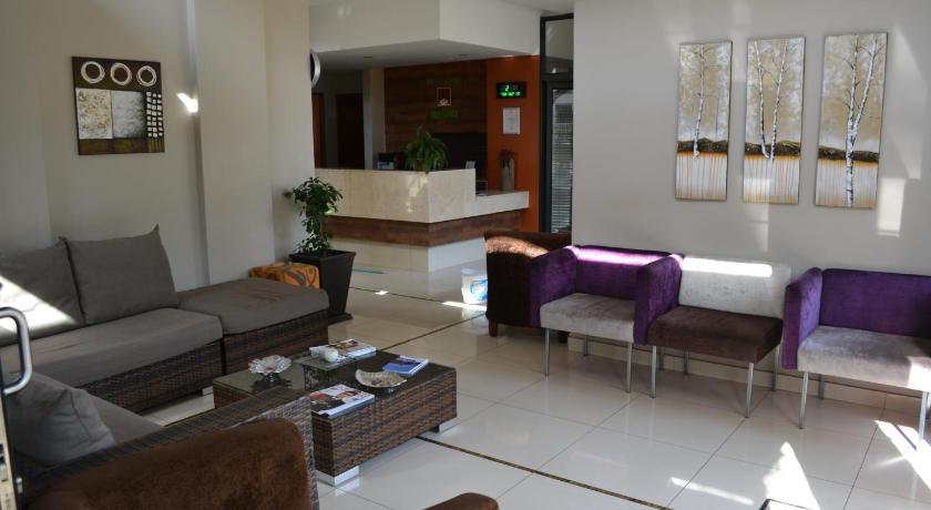 a living room filled with furniture and a large window, Mesami Hotel in Durban