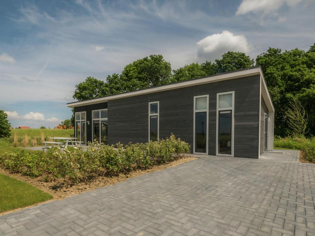 Modern chalet at the edge of a forest near the Oosterschelde