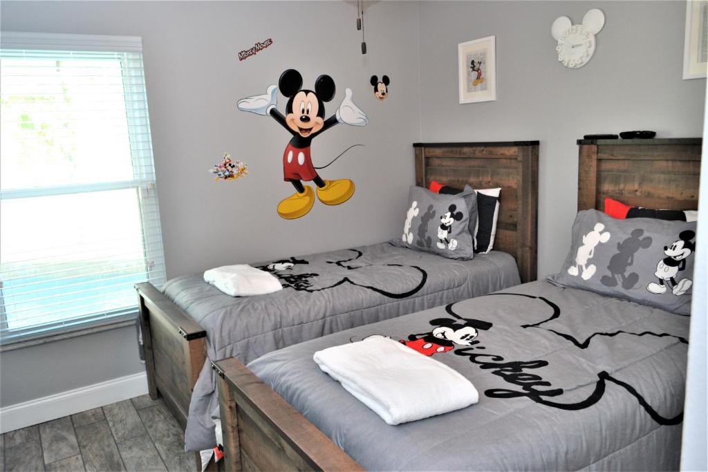 Mickeys Landing - Luxurious 4BR with 2 Master Suites, Privacy Fenced Pool & Hot Tub BBQ Game RM 2 miles to Disney! image