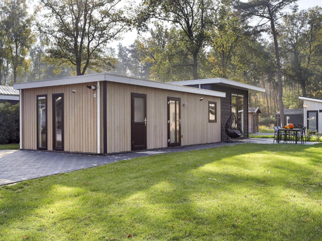 Modern wellness chalet with a smart TV, next to the forest photo 2