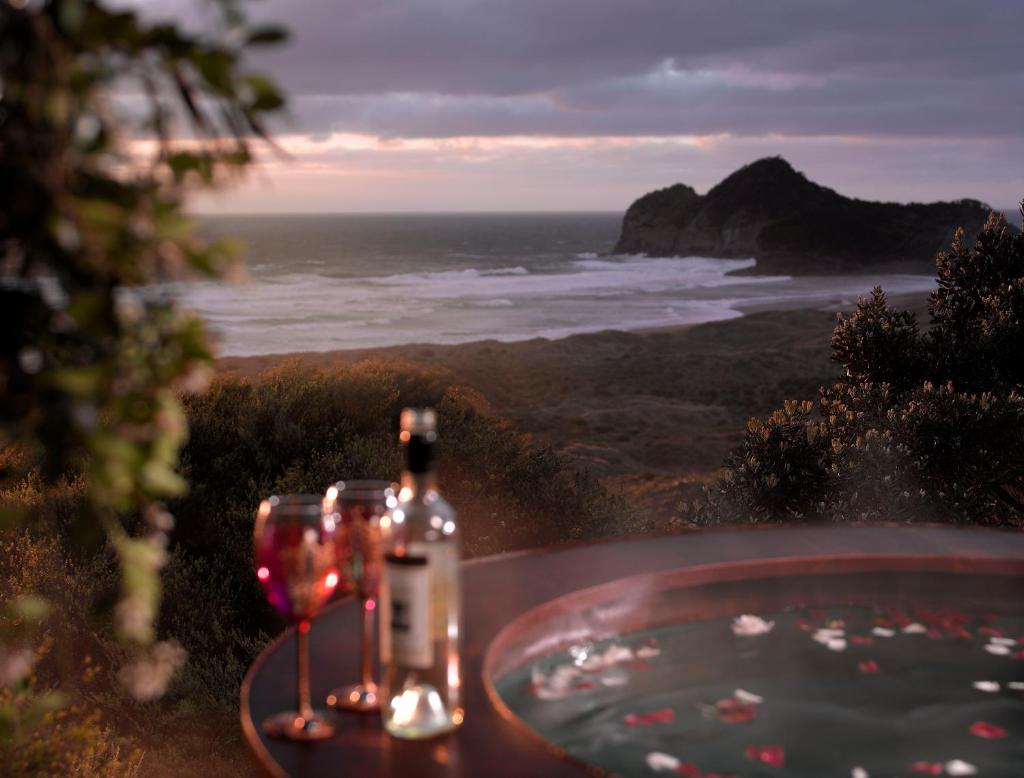 Bethells Beach Cottages - Tap to explore photos