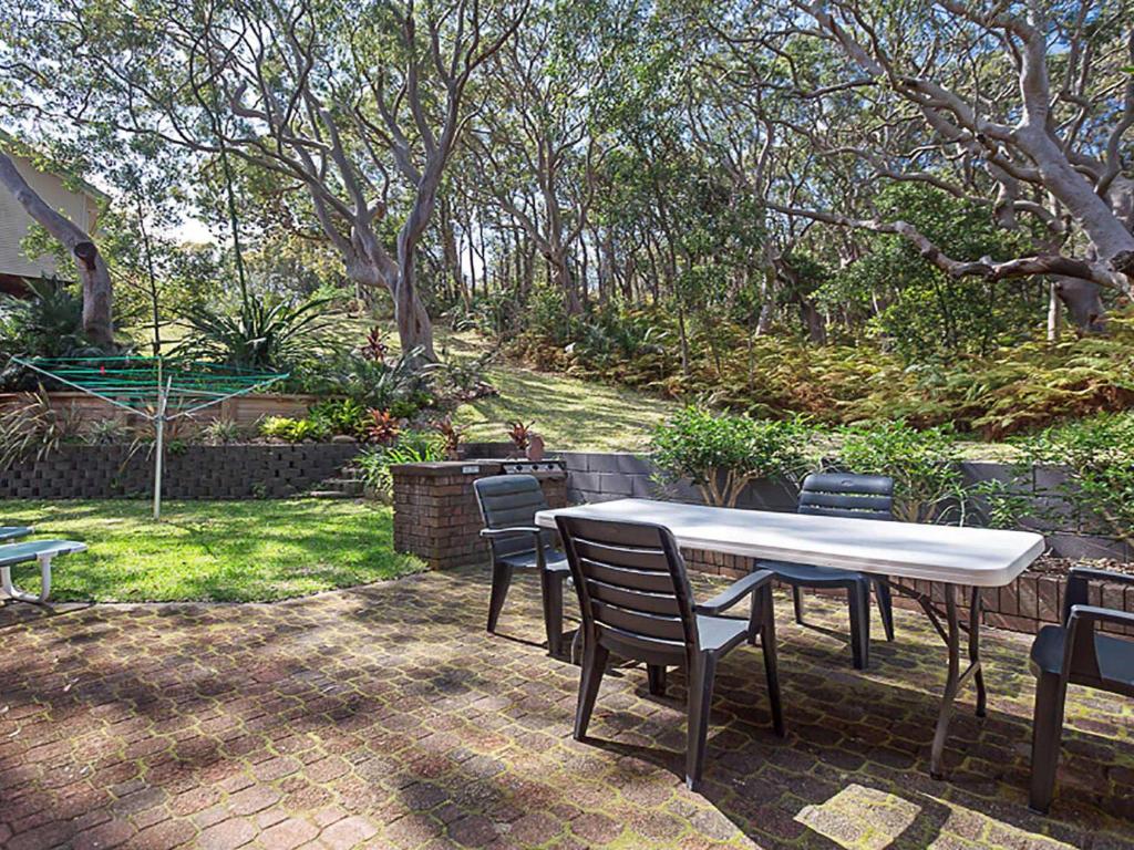 Adriana 3 unit with a backyard