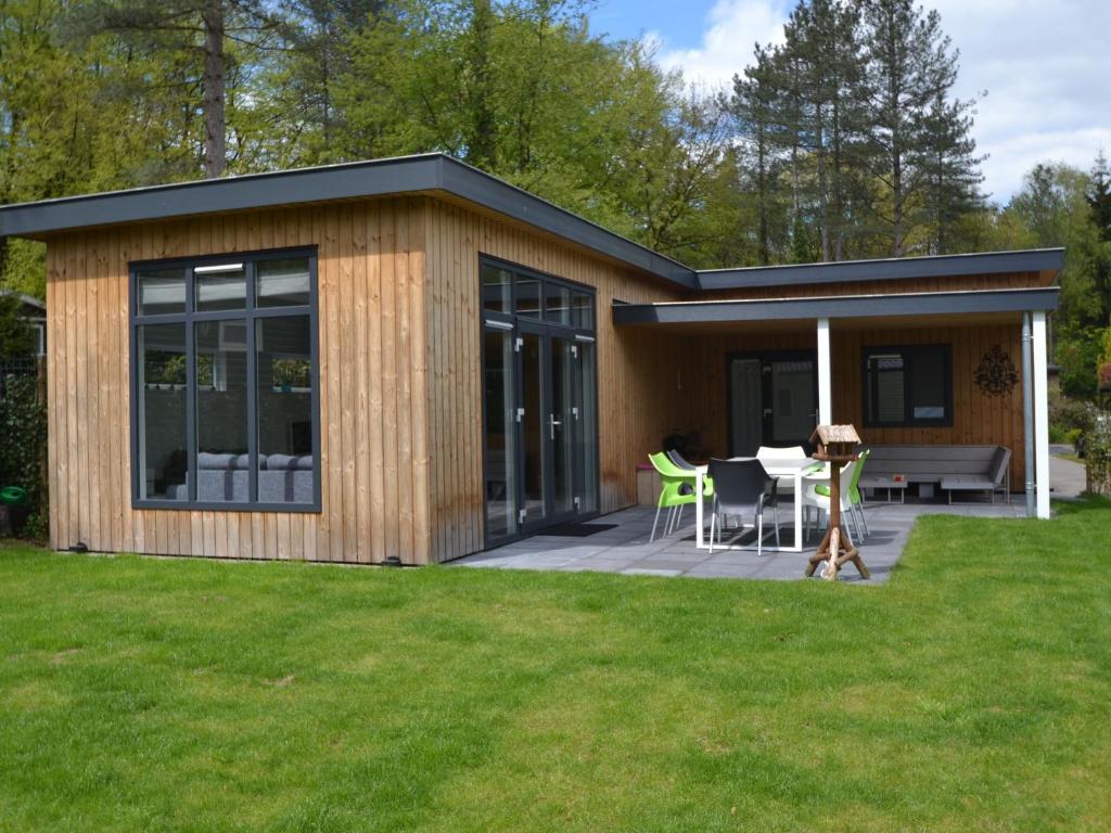 Modern chalet with covered terrace in nature photo 1