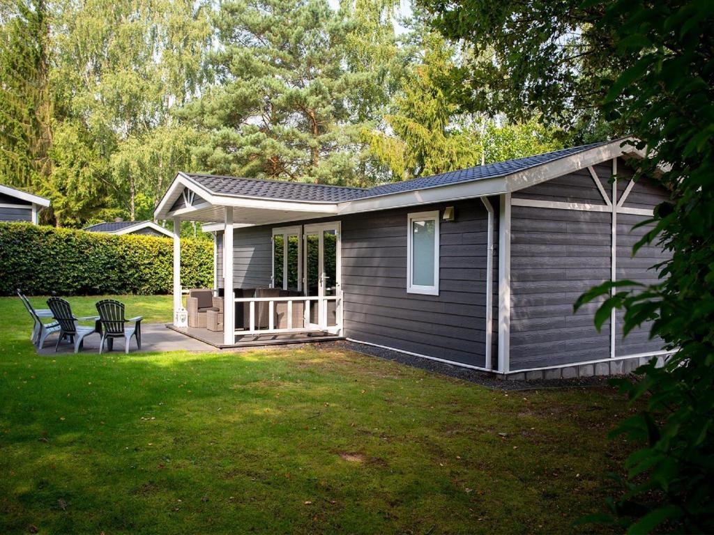 Modern chalet with covered terrace in nature photo 2