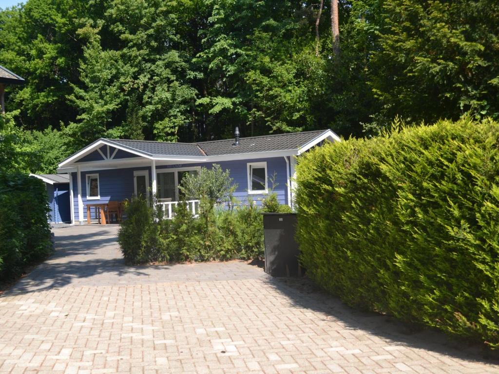 Lovely chalet with covered terrace in a holiday park on the edge of the forest