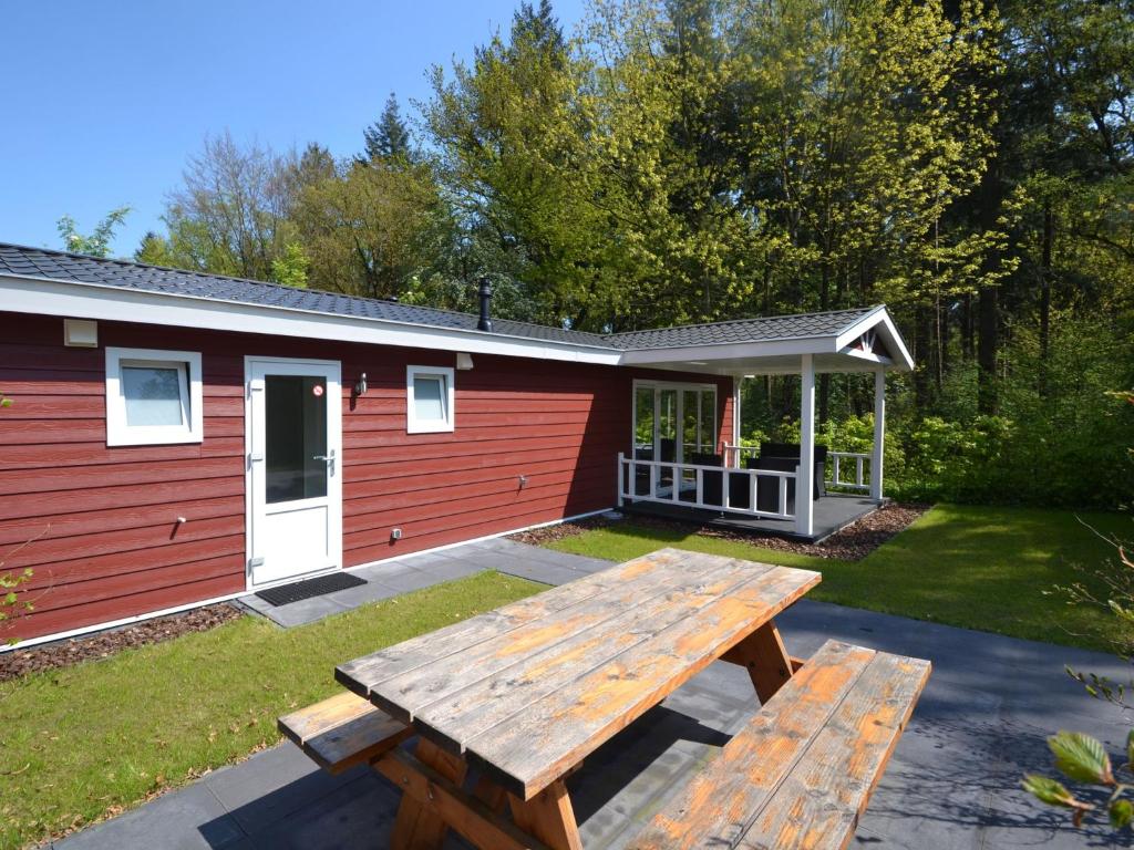 Lovely chalet with covered terrace in a holiday park on the edge of the forest photo 1