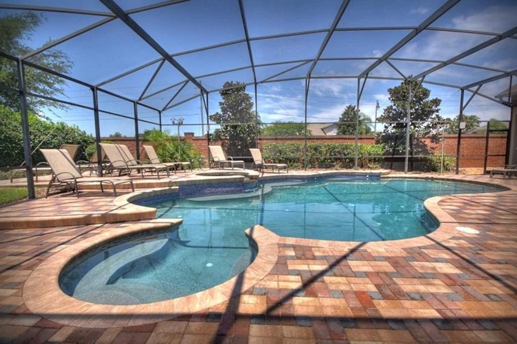 Mickeys Getaway - CUSTOM 8BR Luxurious Retreat Pool Hot Tub Theater RM Gym! Outdoor Kitchen 2 Miles to Disney image