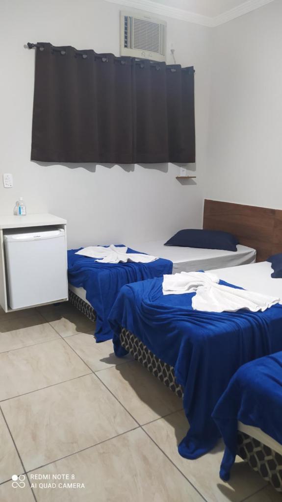 Quarto com frigobar,ar e garagem gratuita photo 3