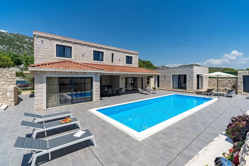 NEW! Stylish Villa Neven with 44sqm heated private pool, 4 en-suite bedrooms, 2 living and dining areas, wine cellar photo 3
