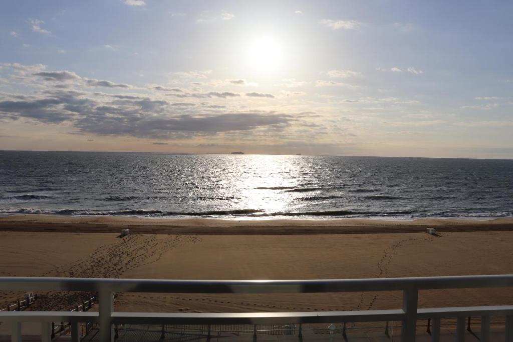 Oceanfront beach, sky, & dolphins photo 1