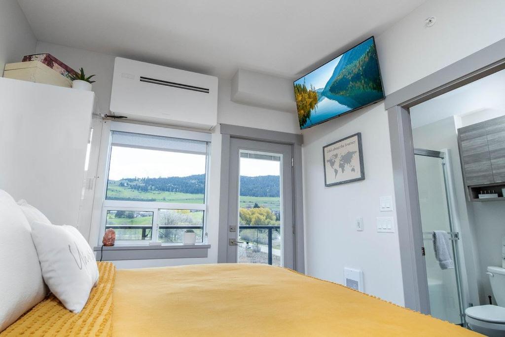 Top Floor on Okanagan Lake with AC & Heated Pool photo 1