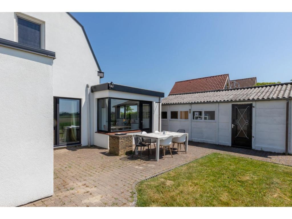 characteristic house in a rural location in the village of Zuidzande with garden photo 3