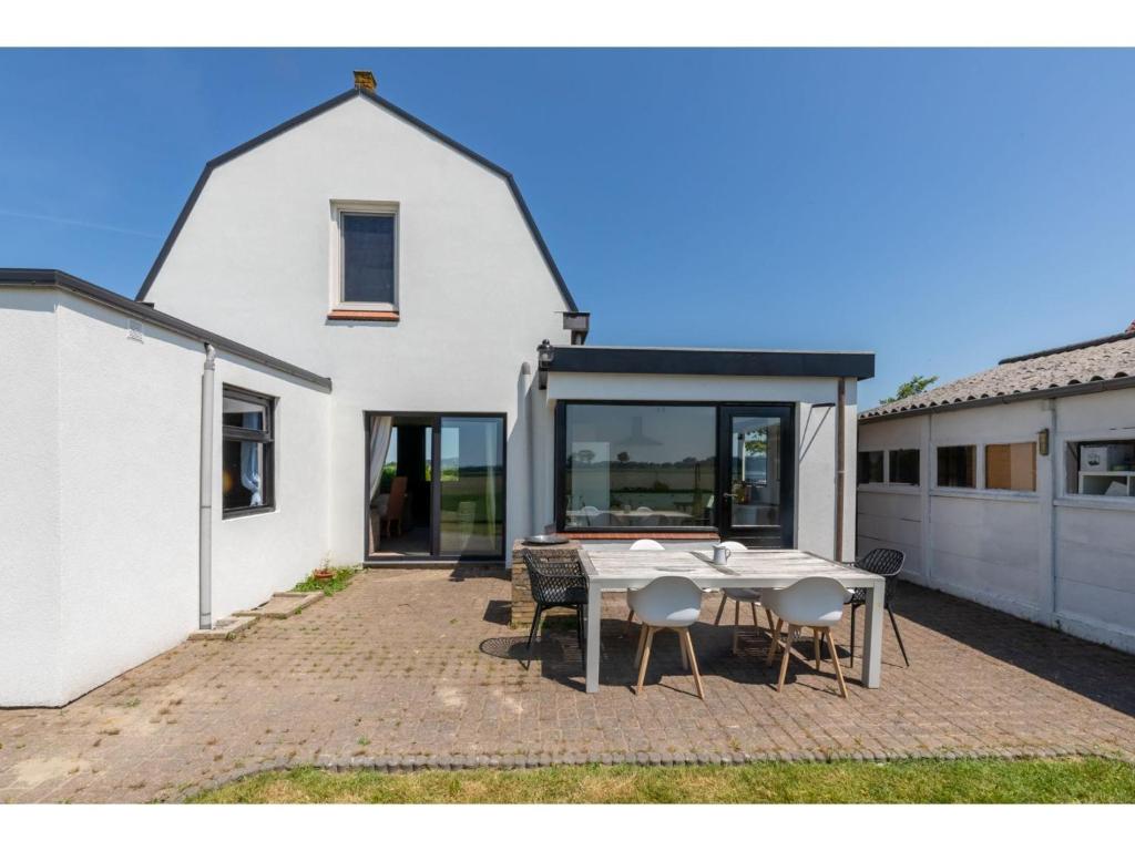 characteristic house in a rural location in the village of Zuidzande with garden photo 1