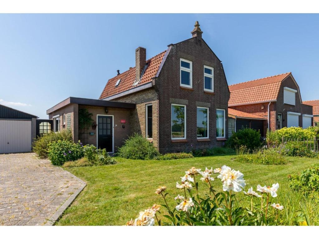 characteristic house in a rural location in the village of Zuidzande with garden photo 2
