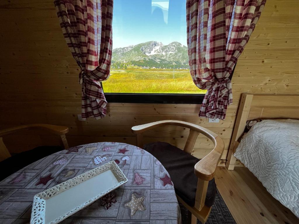 Village cottages in mountains- Green Field photo 2