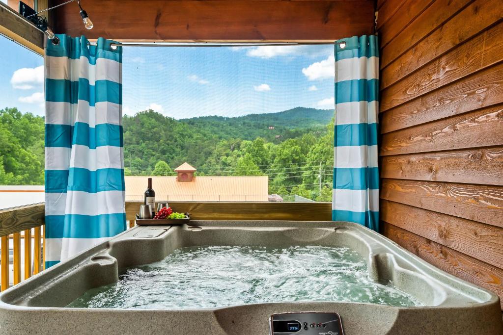 SmokiesBoutiqueCabins would love to host you at Dolly's Cute Cabin! 4 Suites - Hot Tub, Fire Pit, Game Room photo 2
