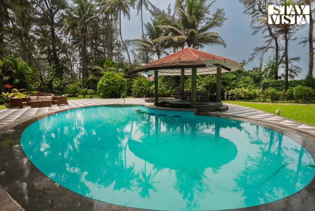 Sea Breeze by StayVista - Beachside bliss with a splash of creativity with Pool, gazebo, lush lawn, and an artistically inspired house photo 2