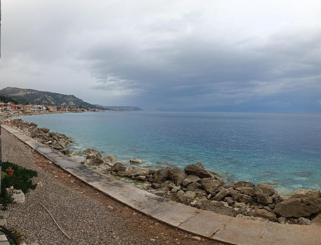 House next to the sea side photo 1