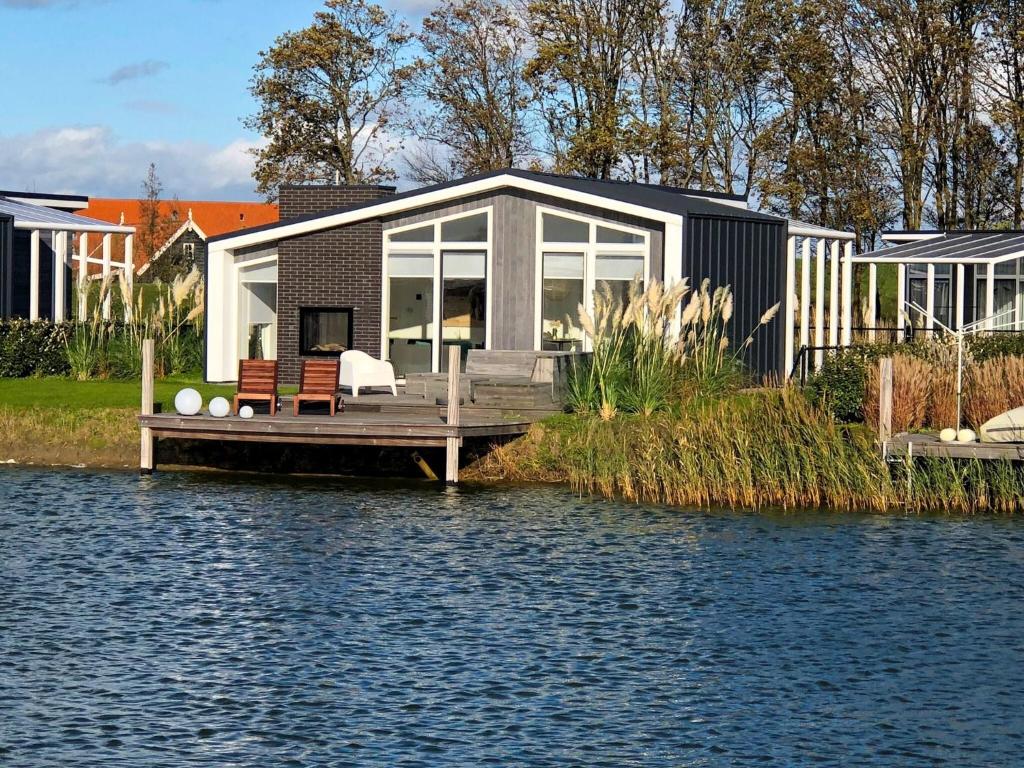 Modern chalet with jetty and terrace near the Oosterschelde