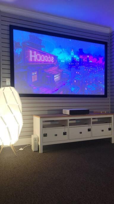 Plush 2 Bed Getaway With 100 Inch Projector & Sectional image