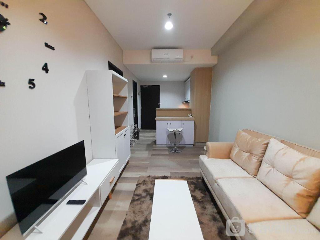 Elegant and Spacious 1BR at Patraland Amarta Apartment By Travelio photo 1
