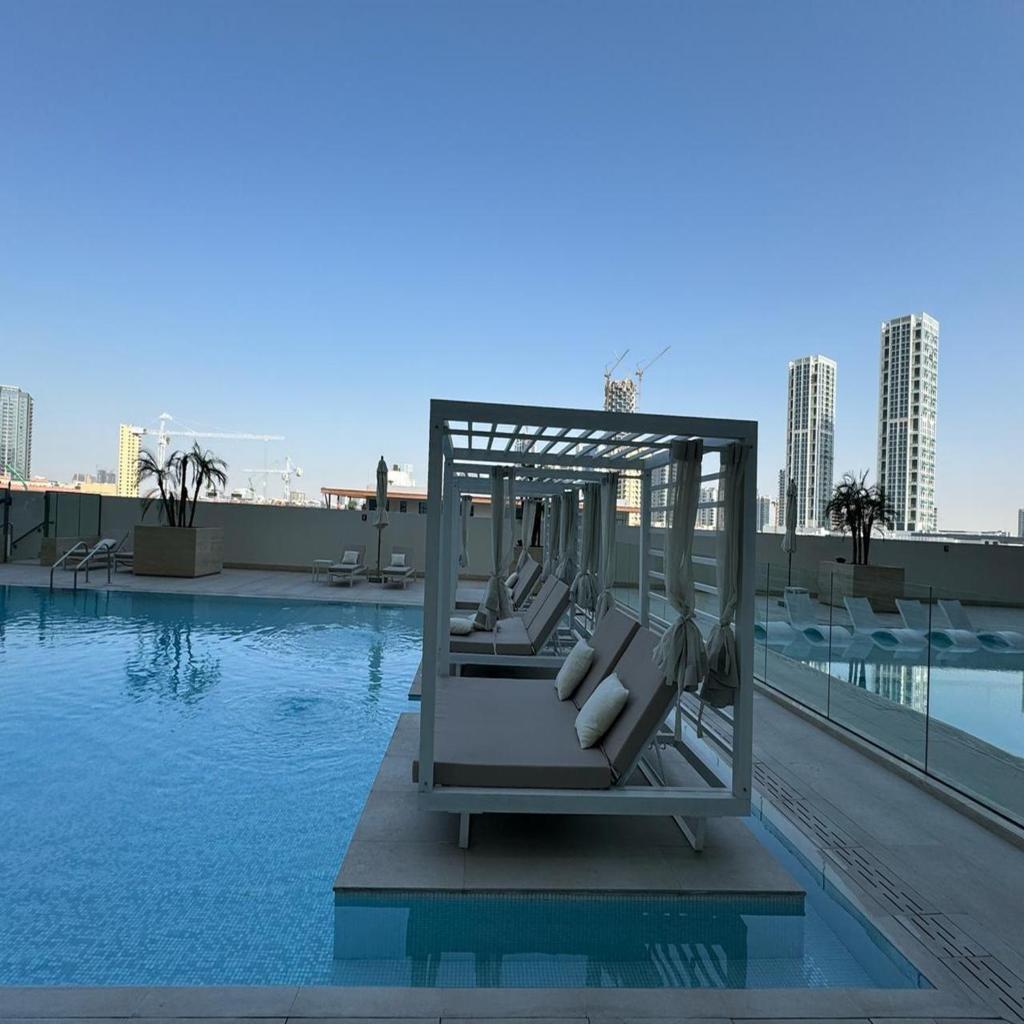 Luxurious Belvilla 1BR JVC with Pool, Gym & BBQ Access - Tap to explore photos