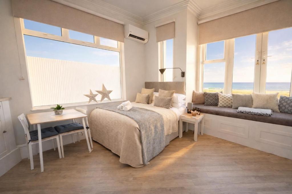Beachfront Studio with Sea Views & AC, The Compact Coastal Crib - Tap to explore photos