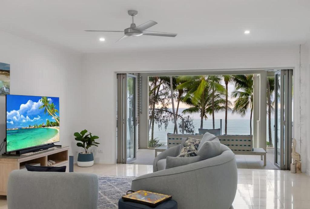 Aqua Aura - Bask in Beachfront Living - Tap to explore photos