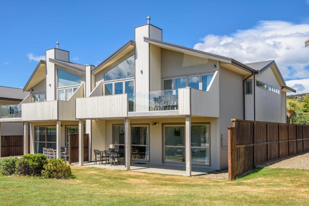 a large white house with a large window, Deluxe Apartments Wanaka in Wanaka
