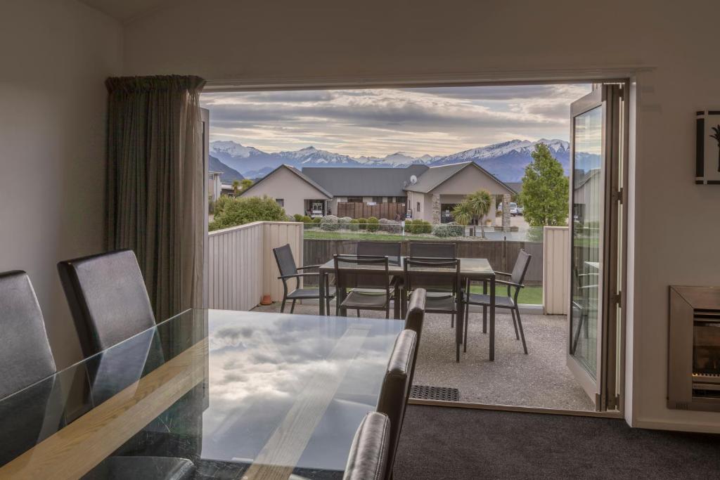 a living room with a table and chairs, Deluxe Apartments Wanaka in Wanaka