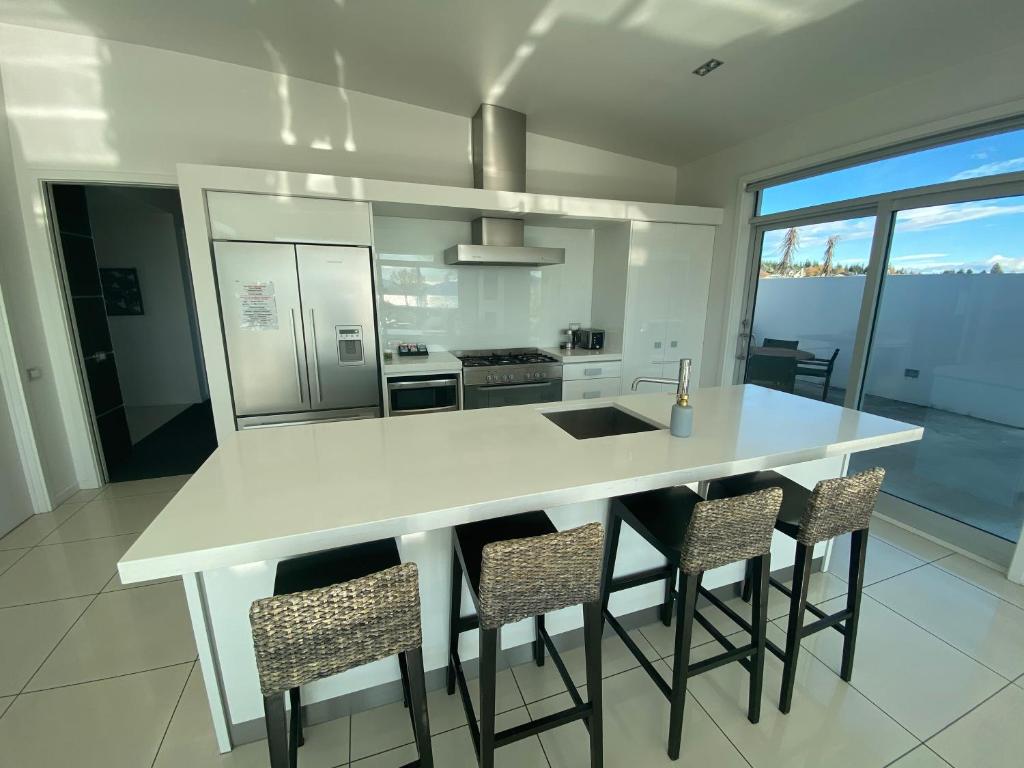 a kitchen with a table, chairs and a refrigerator, White House in Lake Tekapo
