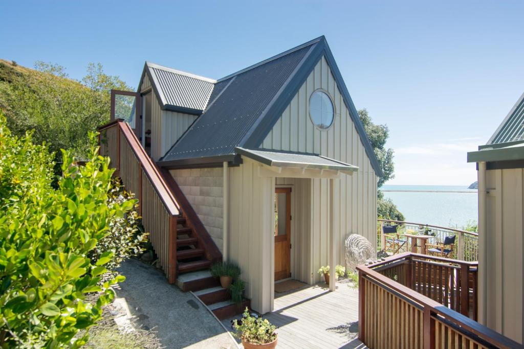 a house with a blue roof and a blue door, Cable Bay Nest in Nelson