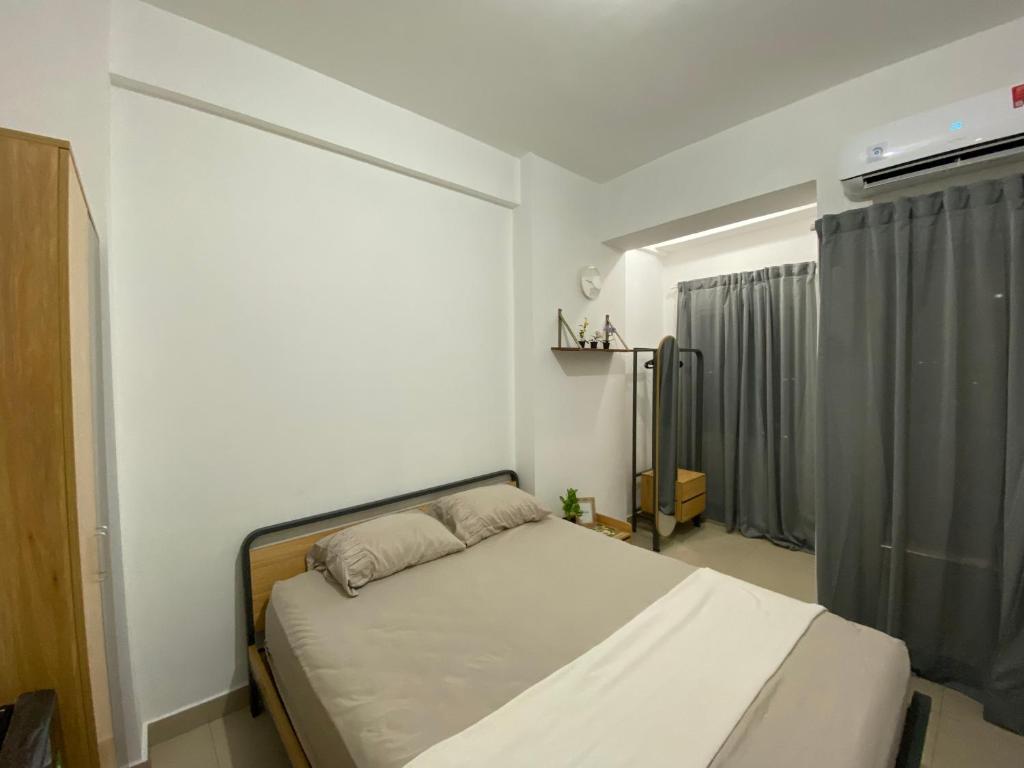 Minimalist room at The Nest Apartment by Popobella Near Puri Indah West Jakarta, Jakarta