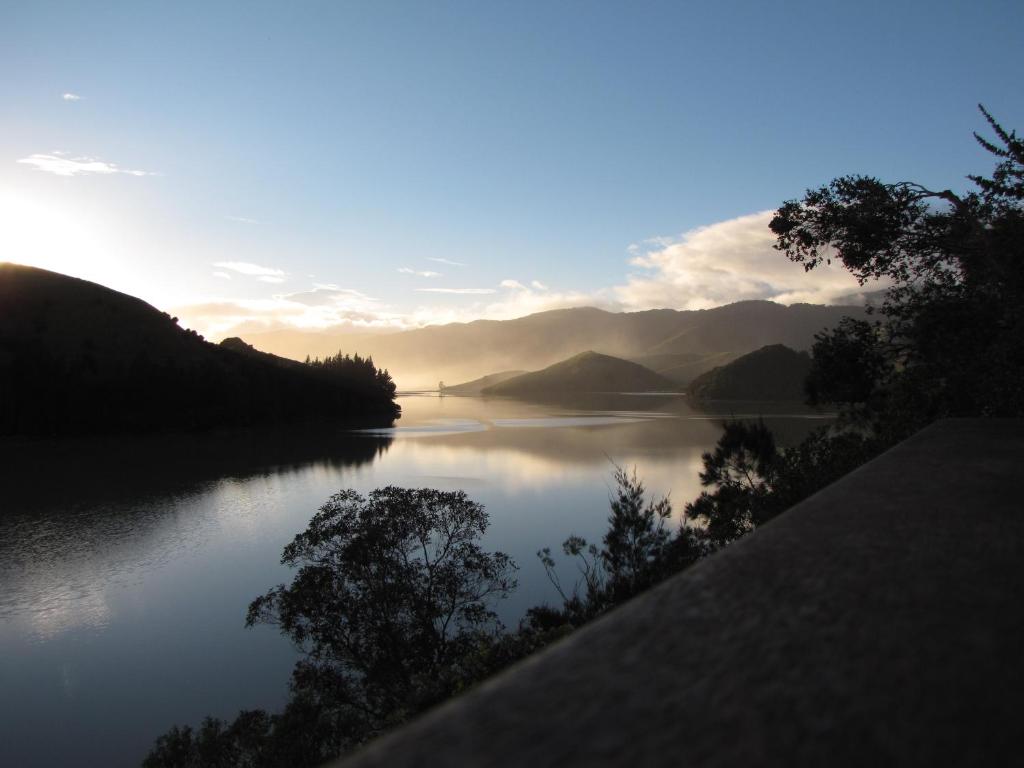 a lake with a view of a mountain range, Cable Bay Nest in Nelson