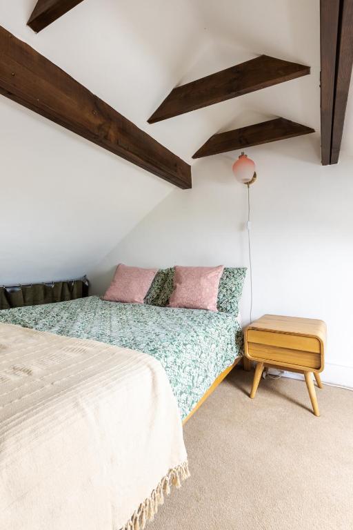 En-suite with double bed on mezzanine and desk in family home, Hertford
