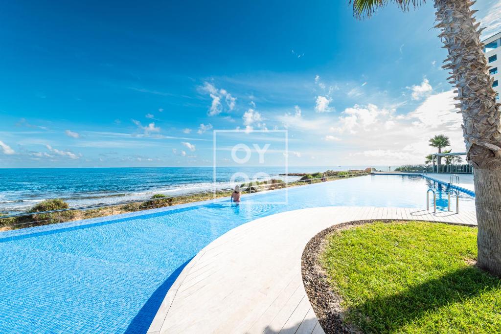 Beachfront Bliss apt, with heated pool, by OYOOSTAYS - 1