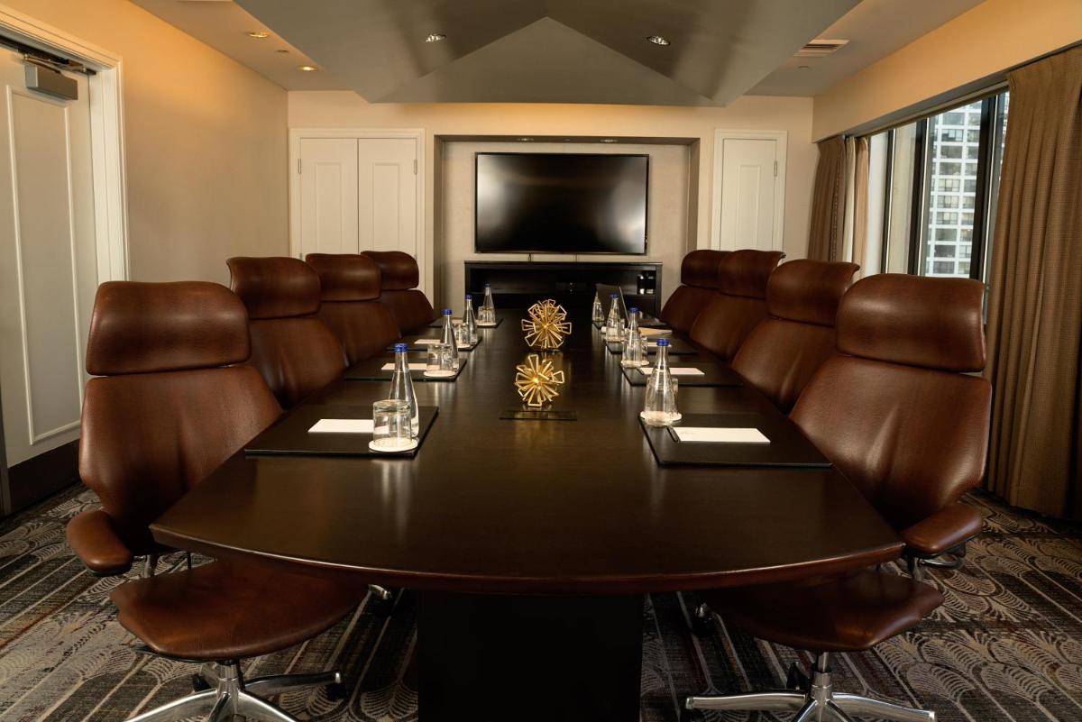Boardroom with a conference table and leather chairs at The Gwen in Chicago