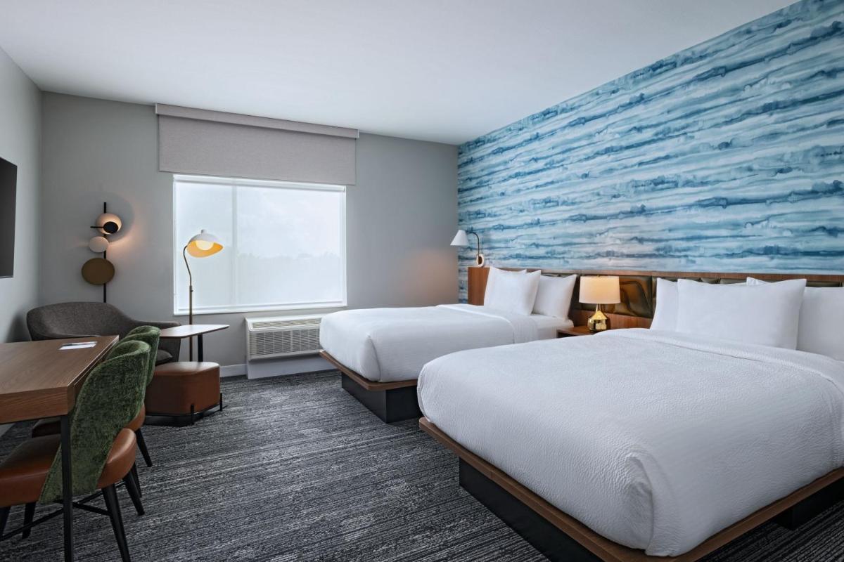 Suite with beds, seating, and workspace at TownePlace Suites by Marriott Stafford Sugar Land