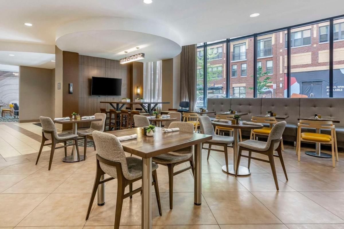 Restaurant seating with tables and large windows at Cambria Hotel Rockville