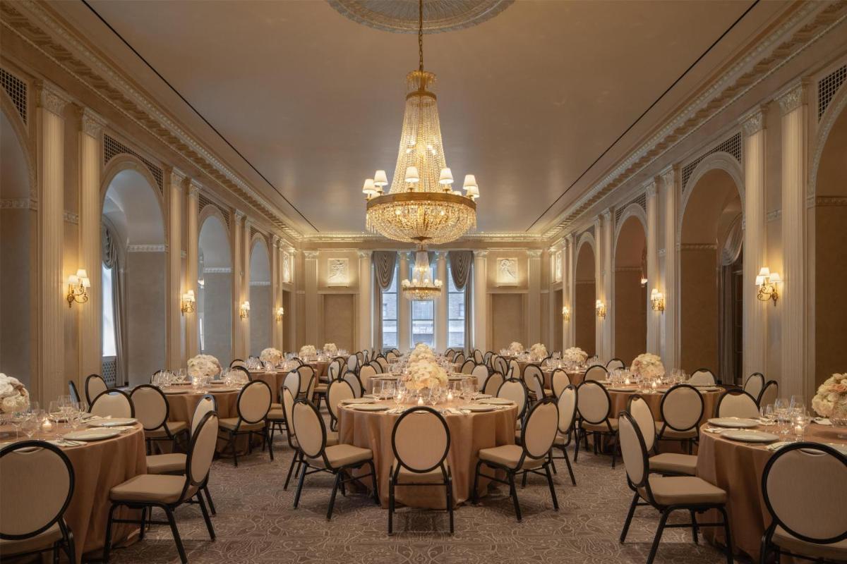 Waldorf Astoria New York banquet room with round tables and chandeliers
