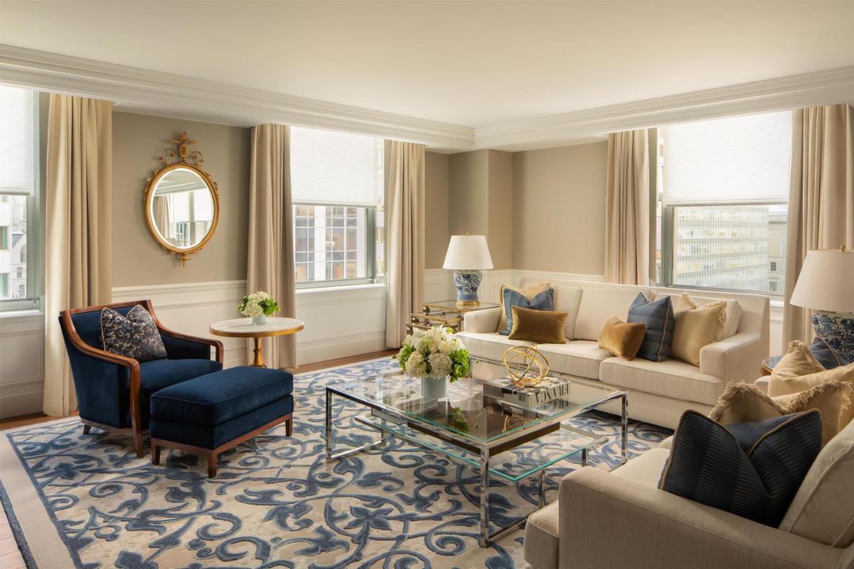 Living area of a Waldorf Astoria New York suite with blue and cream seating