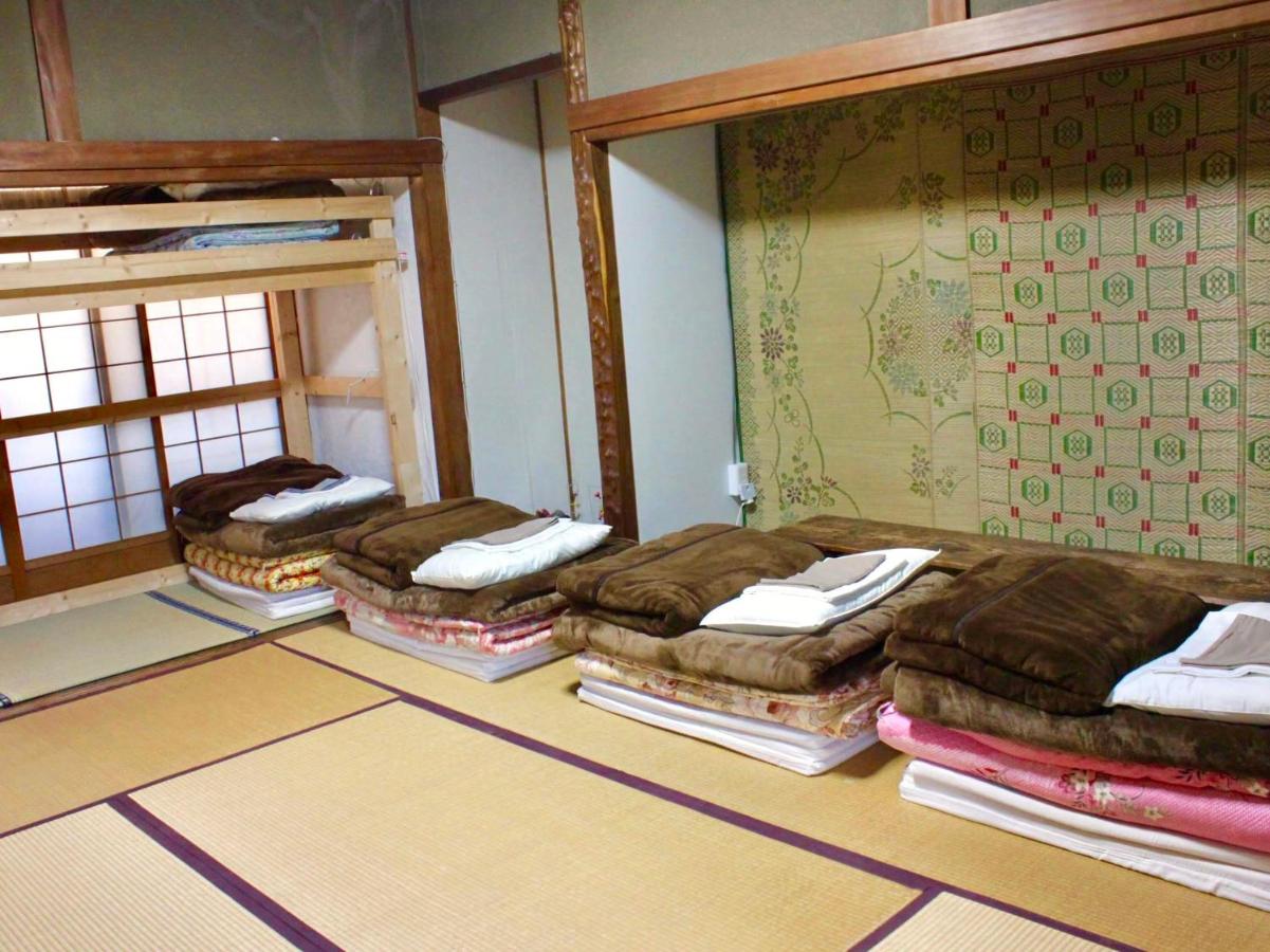 Cama individual tipo futón en una habitación compartida para mujeres de estilo japonés