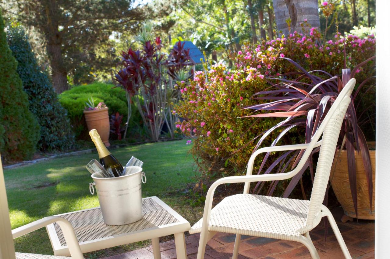 Silver ice bucket with champagne bottle sits on white table at dog-friendly Fairway Motor Inn in Pambula.