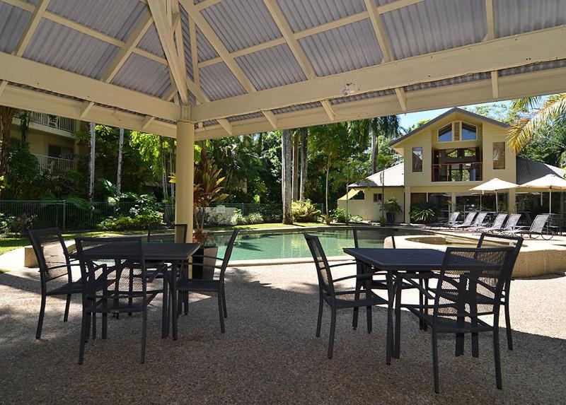 Black metal patio tables and chairs sit at pet-friendly Port Douglas Sands Resort in Port Douglas.