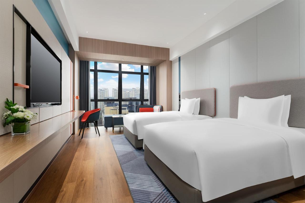 Two white beds are in room at pet-friendly Holiday Inn Express Nanning Convention And Exhibit by IHG in Nanning.