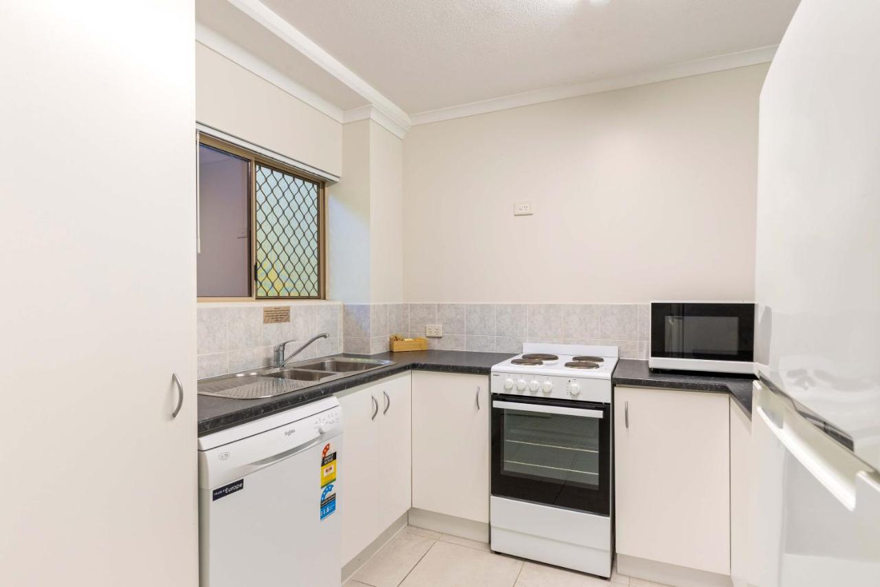 White electric stove with black cooktop stands on countertop at dog-friendly Port Douglas Sands Resort in Port Douglas.