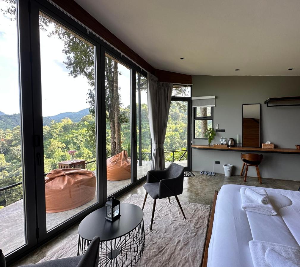 Two tan bean bag chairs sit on balcony at dog-friendly Camp Mai Mee Chue in Pong Yaeng.