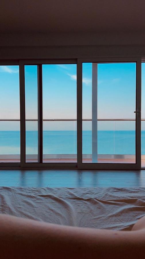 Person with bare legs lies on rumpled white sheet at dog-friendly Casa Mila Apartments & Bungalows in Ulcinj.