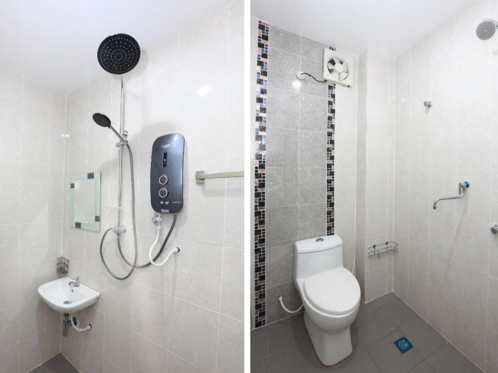 White ceramic toilet with mosaic tile strip sits at dog-friendly OYO 89888 Dz Residence Guest House in Kota Bharu.